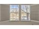 Sunlit view from shuttered windows overlooking green space and street at 112 W Sterne Pkwy, Littleton, CO 80120