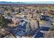 Overhead view of home with solar panels in established neighborhood with mountain views at 7077 Ammons St, Arvada, CO 80004