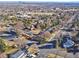 Wide aerial view showcasing the neighborhood with lush trees and community pools at 7077 Ammons St, Arvada, CO 80004