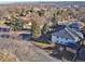 Bright and sunny aerial view of the home with mature landscaping and a neighborhood view at 7077 Ammons St, Arvada, CO 80004