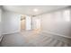 Spacious bedroom with neutral carpet and doorways leading to a closet and the main hallway at 7077 Ammons St, Arvada, CO 80004