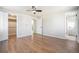 Neutral bedroom with hardwood floors, two closets, and a ceiling fan at 7077 Ammons St, Arvada, CO 80004