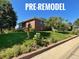 Pre-remodel image of a brick two-story home with a well-maintained front lawn at 7077 Ammons St, Arvada, CO 80004