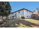 Renovated two-story home with white brick exterior, new staircase and landscaped yard at 7077 Ammons St, Arvada, CO 80004