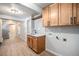 Laundry room featuring new wood floors, a sink, cabinets and washer/dryer hookups at 7077 Ammons St, Arvada, CO 80004