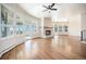 Bright living room with a cozy fireplace, hardwood floors and an abundance of natural light at 7077 Ammons St, Arvada, CO 80004