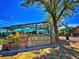 Entrance to Olde Town Arvada with a stone sign and outdoor seating areas at 7077 Ammons St, Arvada, CO 80004