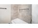 Shower stall featuring niche, neutral tiling, and fixtures at 7077 Ammons St, Arvada, CO 80004