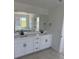 Elegant bathroom featuring a double vanity, modern fixtures, and plenty of cabinet space at 8836 Whiteclover St, Littleton, CO 80125