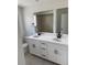 Bathroom featuring a double vanity, modern fixtures, and ample counter space at 8836 Whiteclover St, Littleton, CO 80125