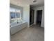 Luxurious bathroom featuring a soaking tub, separate shower, and stylish tile flooring at 8836 Whiteclover St, Littleton, CO 80125