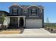 Charming two-story home featuring a two-car garage, covered porch, and modern exterior paint at 8836 Whiteclover St, Littleton, CO 80125