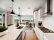 Well-lit kitchen with an island, stainless-steel appliances, and open dining area at 8836 Whiteclover St, Littleton, CO 80125