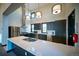 Modern kitchen featuring stainless steel appliances, white quartz counters, and dark cabinetry at 8836 Whiteclover St, Littleton, CO 80125