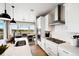 Well-lit kitchen with an island, stainless-steel appliances, and open dining area at 8836 Whiteclover St, Littleton, CO 80125