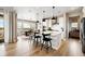 Open-concept kitchen featuring white cabinetry, an island with seating, and modern appliances at 8836 Whiteclover St, Littleton, CO 80125