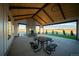 Covered patio featuring picnic tables, a stone fireplace, and views of open land at 8836 Whiteclover St, Littleton, CO 80125