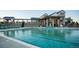Outdoor community pool with lounge chairs and a view of the clubhouse at 8836 Whiteclover St, Littleton, CO 80125