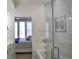 Bathroom with tub and shower combination, leading to the bedroom through an open doorway at 2147 N Downing St, Denver, CO 80205