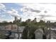 Scenic city view featuring downtown skyscrapers rising above lush trees and charming rooftops at 2147 N Downing St, Denver, CO 80205