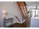 Open entryway with modern floating staircase, hardwood floors, and stylish console table and decor at 2147 N Downing St, Denver, CO 80205