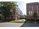Modern townhomes with red brick exteriors and well-maintained front lawns near a paved street at 2147 N Downing St, Denver, CO 80205