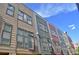 Colorful townhouse exteriors with modern windows and small balconies under a blue sky at 2147 N Downing St, Denver, CO 80205