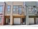 Three modern townhouses, each with unique siding and attached garages, offer urban living at 2147 N Downing St, Denver, CO 80205