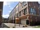 Street view of modern brick and siding townhomes behind a black metal fence and gate at 2147 N Downing St, Denver, CO 80205
