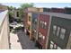 Aerial view of colorful modern townhomes and garage doors with street parking, and gated yards at 2147 N Downing St, Denver, CO 80205