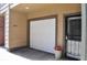 Attached white garage with carriage door, address number 2147, and covered front entryway at 2147 N Downing St, Denver, CO 80205