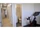 Hallway view of a half bathroom and exercise room, featuring a Peloton bike at 2147 N Downing St, Denver, CO 80205
