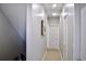 Bright hallway with modern art and neutral walls leading to other rooms with neutral colored doors at 2147 N Downing St, Denver, CO 80205