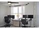 Bright home office with two desks, monitors, and a large window for natural light at 2147 N Downing St, Denver, CO 80205
