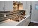 Contemporary kitchen with gas cooktop, stainless appliances, and stylish tile backsplash at 2147 N Downing St, Denver, CO 80205