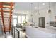 Open-concept kitchen with white cabinets, stainless steel appliances, island, and view of living room at 2147 N Downing St, Denver, CO 80205