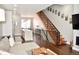 Bright open concept space with hardwood floors and a modern wooden and steel staircase at 2147 N Downing St, Denver, CO 80205