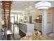 Open-concept living area with hardwood floors, modern kitchen, and stylish staircase at 2147 N Downing St, Denver, CO 80205