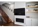 Cozy living room with fireplace, tv and modern shelving in an open layout with staircase access at 2147 N Downing St, Denver, CO 80205