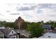 Charming neighborhood view with brick church, tree-lined streets, and classic homes under cloudy skies at 2147 N Downing St, Denver, CO 80205
