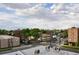 Neighborhood view featuring tree-lined streets, mixed architecture, and pedestrian crossing under cloudy skies at 2147 N Downing St, Denver, CO 80205