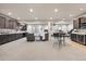 Finished basement includes a wet bar, a seating area, a home gym, a carpet, and recessed lighting at 7950 Piney River Ave, Littleton, CO 80125