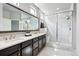 Modern bathroom with double vanity, stylish tile work, and a glass-enclosed shower at 7950 Piney River Ave, Littleton, CO 80125