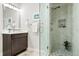Modern bathroom with glass shower door, a tiled shower, vanity, and a framed picture on the wall at 7950 Piney River Ave, Littleton, CO 80125