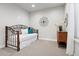 Spare bedroom features carpet floors, a daybed with decorative pillows, and a dresser with decorations at 7950 Piney River Ave, Littleton, CO 80125