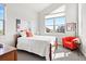Bright bedroom features a wooden bed, an orange chair and a big window bringing natural light to the room at 7950 Piney River Ave, Littleton, CO 80125