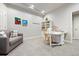 Bonus room featuring a comfortable sofa, crafting table, and ample storage space at 7950 Piney River Ave, Littleton, CO 80125