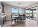 Inviting dining area with modern light fixture and backyard views, perfect for Gathering meals at 7950 Piney River Ave, Littleton, CO 80125
