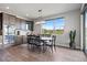 Elegant dining area with stylish light fixture, spacious table, and sliding glass door to outdoor patio at 7950 Piney River Ave, Littleton, CO 80125