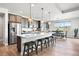 Modern kitchen with stainless steel appliances, large island with breakfast bar, and bright dining area at 7950 Piney River Ave, Littleton, CO 80125